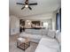 Spacious living room featuring a plush sectional, modern fan, and seamless kitchen view at 1607 Tundra Ln, Denver, NC 28037
