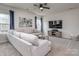 Cozy living room with a plush sectional sofa, modern decor, and ample natural light at 1607 Tundra Ln, Denver, NC 28037