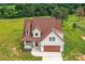Aerial shot of charming home with a beautiful lawn and inviting front porch and curb appeal at 181 Lone Pine Rd, Statesville, NC 28625