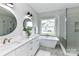 Bright bathroom featuring double vanity, soaking tub, and glass-enclosed shower at 181 Lone Pine Rd, Statesville, NC 28625