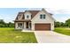 Charming two-story home with a brown garage, inviting front porch, and well-manicured lawn at 181 Lone Pine Rd, Statesville, NC 28625