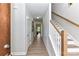 Bright hallway with hardwood floors and a staircase leading to the upper level of the home at 181 Lone Pine Rd, Statesville, NC 28625