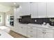 Bright kitchen with white cabinetry, stone countertops, gas range, stainless steel appliances, and stylish backsplash at 181 Lone Pine Rd, Statesville, NC 28625