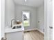 Bright laundry room features modern sink and window with outside view at 181 Lone Pine Rd, Statesville, NC 28625