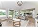 Open concept living room featuring a vaulted ceiling, modern furniture, and views of the outdoor landscape at 181 Lone Pine Rd, Statesville, NC 28625