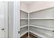 Walk-in pantry features built in shelving and neutral walls and flooring at 181 Lone Pine Rd, Statesville, NC 28625