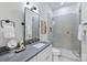 Modern bathroom featuring a sleek vanity, a framed mirror, and a glass-enclosed shower at 1834 Arnold Dr, Charlotte, NC 28205