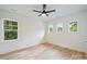 Bright bedroom with hardwood floors, large windows, and a modern ceiling fan at 1834 Arnold Dr, Charlotte, NC 28205