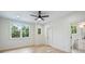 Minimalist bedroom with hardwood floors, bright windows, and a view into the bathroom at 1834 Arnold Dr, Charlotte, NC 28205