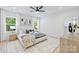 Bright bedroom with large windows, hardwood floors, and a comfortable bed with stylish bedding at 1834 Arnold Dr, Charlotte, NC 28205