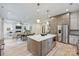 Open-concept kitchen with large island, stainless appliances, and seamless flow to living and dining areas at 1834 Arnold Dr, Charlotte, NC 28205