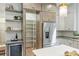 Spacious kitchen showcasing a walk-in pantry, wine cooler, stainless steel refrigerator, and stylish shelving at 1834 Arnold Dr, Charlotte, NC 28205