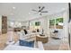 Spacious living room with sleek furniture, ceiling fan, and natural light flowing from large windows at 1834 Arnold Dr, Charlotte, NC 28205