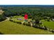 Aerial view of several houses surrounded by trees and fields in a rural setting at 1858 Brevard Place Rd, Iron Station, NC 28080