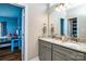 Bathroom with double sinks, granite countertops, grey cabinets and view of blue bedroom at 1858 Brevard Place Rd, Iron Station, NC 28080