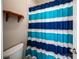 Bathroom showing a blue and white striped shower curtain and toilet at 1858 Brevard Place Rd, Iron Station, NC 28080