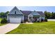 Charming single-Gathering home featuring a well-manicured lawn, a 2-car garage, and a cozy front porch at 1858 Brevard Place Rd, Iron Station, NC 28080