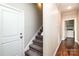 Hallway featuring stairs and laundry room with a washing machine at 1858 Brevard Place Rd, Iron Station, NC 28080