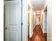 Long hallway with hardwood floors leading to a bathroom and kitchen at 1858 Brevard Place Rd, Iron Station, NC 28080