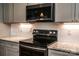 Sleek kitchen featuring modern appliances, granite countertops, and ample storage space at 1858 Brevard Place Rd, Iron Station, NC 28080