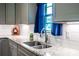 Close up of the sink, counter, cabinets, and window in this modern kitchen at 1858 Brevard Place Rd, Iron Station, NC 28080