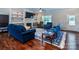 Cozy living room with hardwood floors, a fireplace, built-in shelves and plenty of seating at 1858 Brevard Place Rd, Iron Station, NC 28080