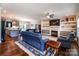 Comfortable living room with hardwood floors, a fireplace, built-in shelves and an open floor plan at 1858 Brevard Place Rd, Iron Station, NC 28080