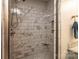 Close-up of tiled shower with shower head, bench, and built-in niche at 1858 Brevard Place Rd, Iron Station, NC 28080