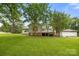Expansive backyard view showcasing the home's exterior, wooden deck, and detached garage at 1983 Burkin Rd, McConnells, SC 29726