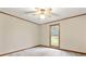 Neutral bedroom features a ceiling fan, soft carpet, and natural light from the window at 1983 Burkin Rd, McConnells, SC 29726