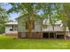 Home exterior featuring siding, brick foundation, and a wooden deck surrounded by trees at 1983 Burkin Rd, McConnells, SC 29726