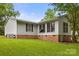 The home's exterior showing siding, brick foundation, windows, and well-maintained lawn at 1983 Burkin Rd, McConnells, SC 29726
