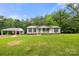 Spacious lot featuring a single-story home and a detached carport with additional storage at 1983 Burkin Rd, McConnells, SC 29726