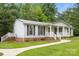 Beautiful single-story home featuring a metal roof, covered porch, and landscaped front yard at 1983 Burkin Rd, McConnells, SC 29726