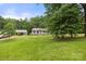 Expansive green yard with a charming single-story home and a detached carport with storage at 1983 Burkin Rd, McConnells, SC 29726