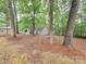 Backyard features multiple storage sheds among the trees at 2070 Stirewalt Rd, China Grove, NC 28023