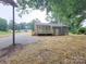 Rear exterior view of home with new deck and gravel driveway at 2070 Stirewalt Rd, China Grove, NC 28023