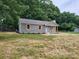 Beautiful single-story home featuring light green siding, wooden shutters, and a well-maintained lawn at 2070 Stirewalt Rd, China Grove, NC 28023
