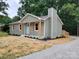 Inviting single-story house with light green siding, complemented by a fresh lawn and landscape at 2070 Stirewalt Rd, China Grove, NC 28023