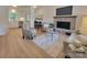 Inviting living room with a brick fireplace, neutral decor, and seamless flow to dining and kitchen areas at 2070 Stirewalt Rd, China Grove, NC 28023