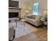 Comfortable living room with a brick fireplace, a cozy sofa, and bright natural light from the large window at 2070 Stirewalt Rd, China Grove, NC 28023