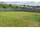 Large, grassy backyard enclosed by a wooden fence, perfect for recreation at 211 Hidden Lakes Rd, Statesville, NC 28677