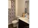 Cozy bathroom featuring a floral shower curtain, toilet, sink, and vanity at 211 Hidden Lakes Rd, Statesville, NC 28677