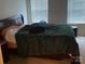 Bedroom with a comfortable bed and natural light from the two windows at 211 Hidden Lakes Rd, Statesville, NC 28677
