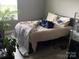 Bedroom featuring neutral walls, a window with blinds, and a plant for added charm at 211 Hidden Lakes Rd, Statesville, NC 28677