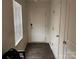 Entryway featuring a storm door and a large window that allows natural light to fill the space at 211 Hidden Lakes Rd, Statesville, NC 28677