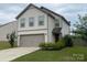 Charming two-story home with a well-maintained lawn and attached two-car garage at 211 Hidden Lakes Rd, Statesville, NC 28677