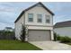 Two-story home featuring an attached two-car garage and well-manicured lawn at 211 Hidden Lakes Rd, Statesville, NC 28677