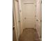 Hallway with carpeted flooring, white trim, and doors at 211 Hidden Lakes Rd, Statesville, NC 28677