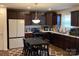 Eat-in kitchen featuring wooden cabinets, modern appliances and a pendant light fixture at 211 Hidden Lakes Rd, Statesville, NC 28677
